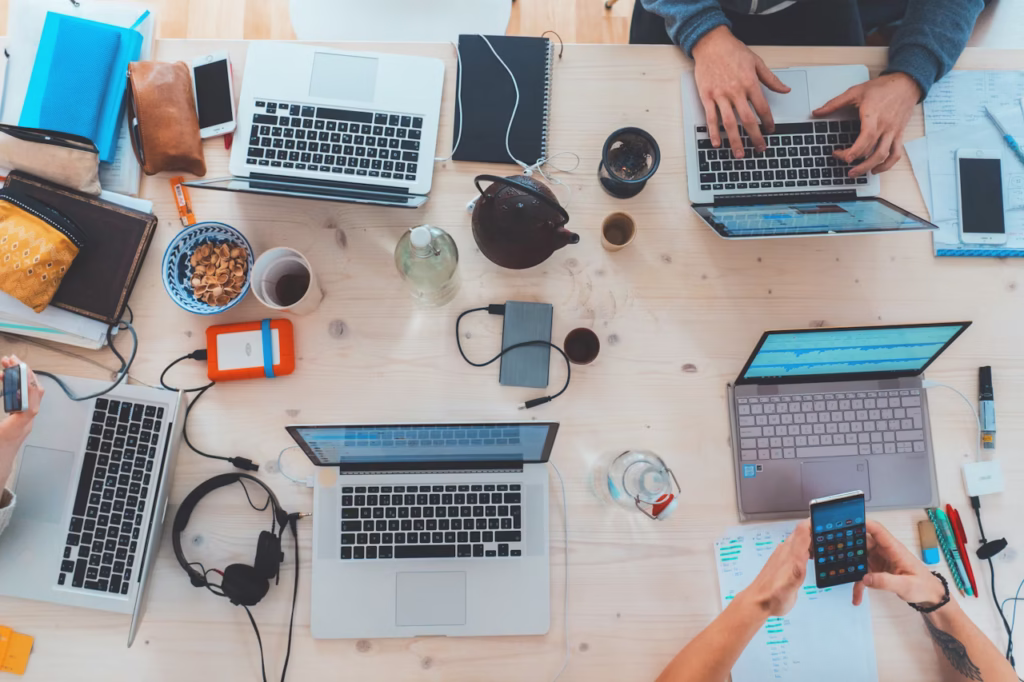 A startup workplace with lots of laptops and personal stuff working to file their SR&ED in canada using DIY SR&ED